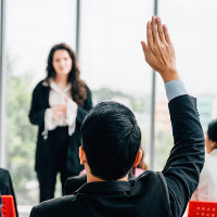 man with raised hand asking a question about extended warranties
