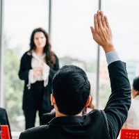 man with raised hand asking a question about extended warranties