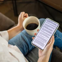 woman at a desk drinking coffee reading the Cuvrd refinance guide