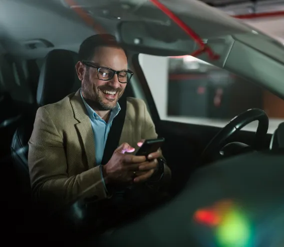 dealership service customer reading a warranty offer text message from Cuvrd