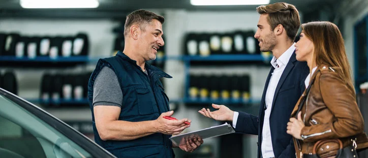 Happy couple getting their car fixed with an affordable extended warranty from the Cuvrd platform