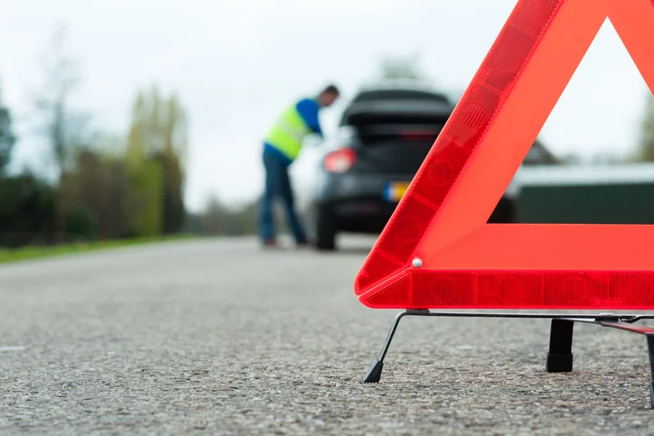 Driver getting roadside assistance with extended warranty