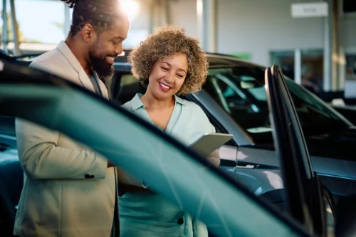 Service department salesperson with tablet selling an extended warranty with the Cuvrd platform