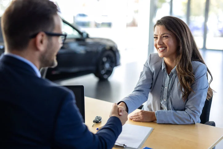 Happy woman buying a new car and extended warranty from the Cuvrd platform